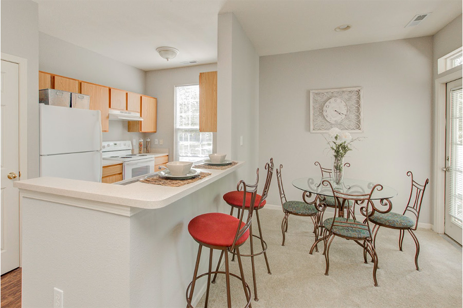The right furnishings can create a beautiful and functional dining room like this one at Ashley Place in Westfield. Dining room with round table and four chairs in compact space