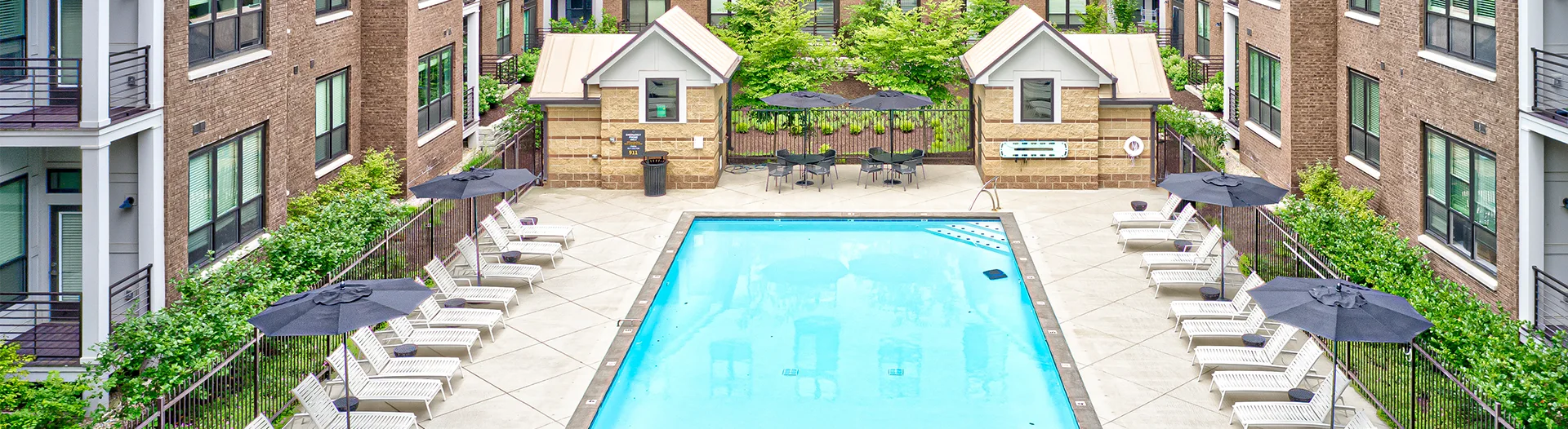 View of the pool area and exterior buildings with balconies at Continuum Apartments