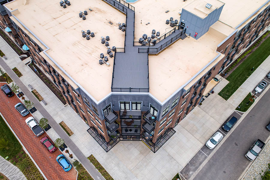 You can walk to your favorite shops and restaurants when you live in a conveniently located apartment building like the one at Midtown Flats Apartments. Midtown Flats bird eye view of the building and sidewalks.