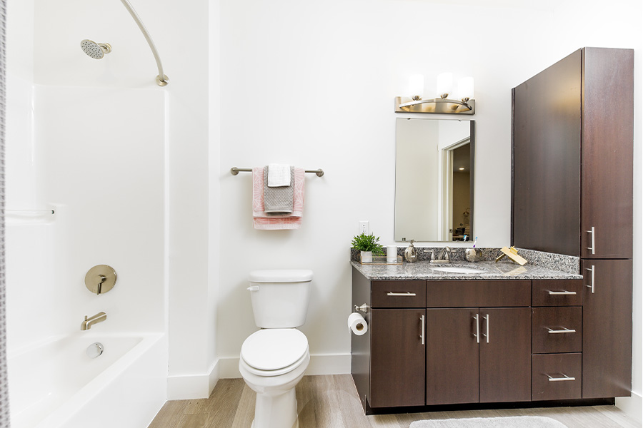 Dark wood cabinets with white walls and wooden floors at Echo Park Bloomington.